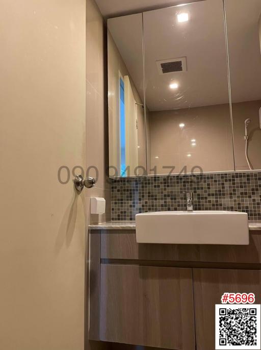 Modern bathroom with a vanity and tiled wall