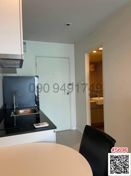 Modern kitchen with stainless steel appliances and adjacent bathroom