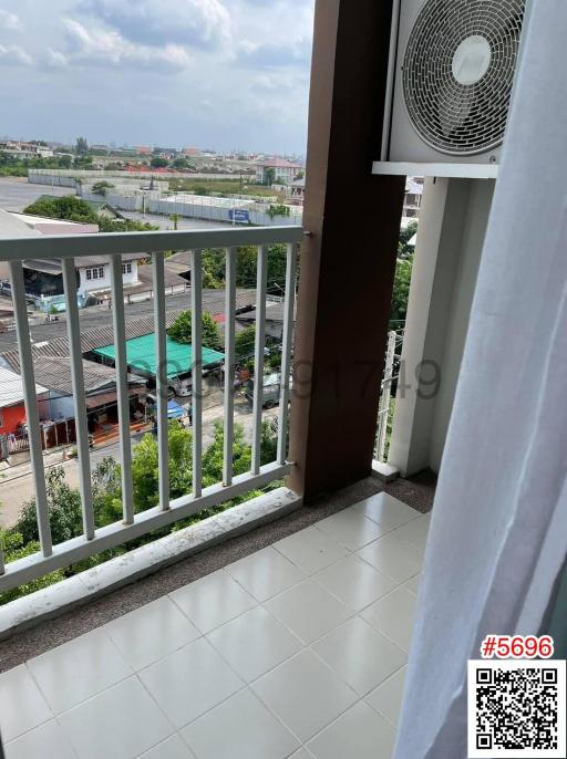 Balcony view with air conditioning unit and urban background