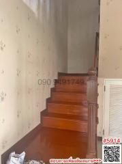 Staircase with wooden steps and floral wallpaper