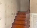 Staircase with wooden steps and floral wallpaper