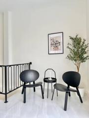 Minimalist interior design in a well-lit building space with chairs and decorative plant