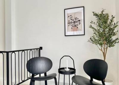 Minimalist interior design in a well-lit building space with chairs and decorative plant