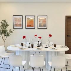 Elegant dining room with modern white table and artwork