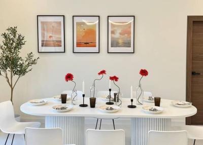 Elegant dining room with modern white table and artwork