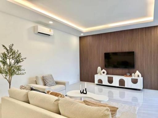 Modern living room interior with large sofa and flat-screen TV