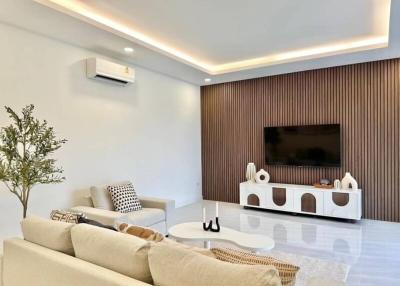 Modern living room interior with large sofa and flat-screen TV