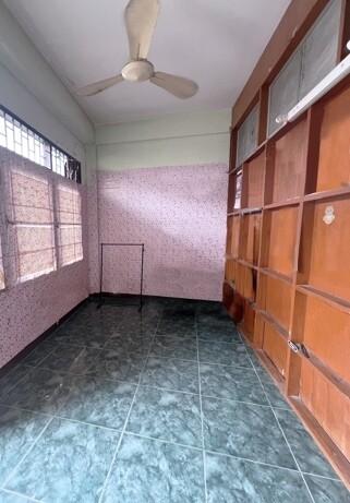 Spacious room with tiled floor and large wooden cabinets