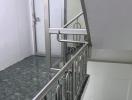 Modern staircase with metal railing in a residence