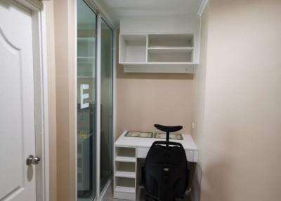Compact home office space with desk and shelving unit