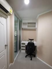 Compact home office space with desk and shelving unit