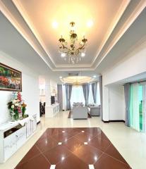 Elegant living room with chandelier lighting and polished floor tiles