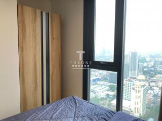 Modern bedroom with floor-to-ceiling windows and city view