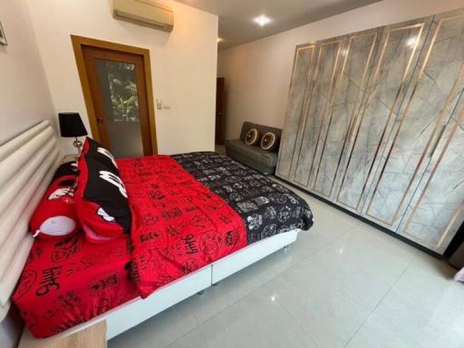 Spacious bedroom with large bed and mirrored wardrobe