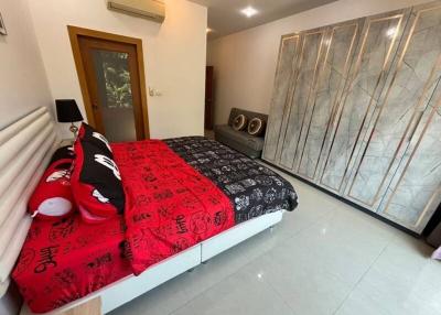 Spacious bedroom with large bed and mirrored wardrobe