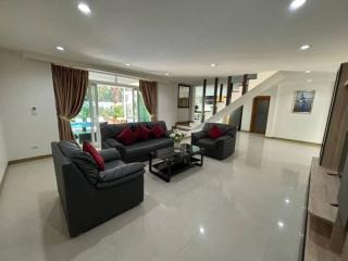 Spacious living room with modern furniture and ample natural light