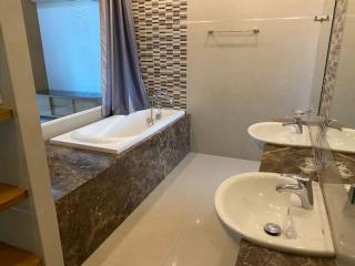 Modern bathroom interior with a bathtub and dual sink vanity