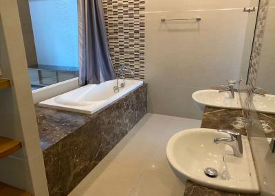 Modern bathroom interior with a bathtub and dual sink vanity