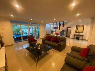 Spacious living room with modern furniture and ample lighting