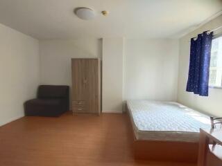 Minimalist bedroom with a single bed and a sofa