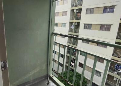 Small balcony with air conditioning unit and view of adjacent buildings