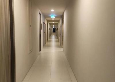 Long, well-lit corridor inside a modern building