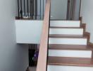 Modern staircase with wooden steps and metal balustrade in a residence