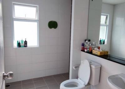 Modern bathroom with white tiles and ample lighting