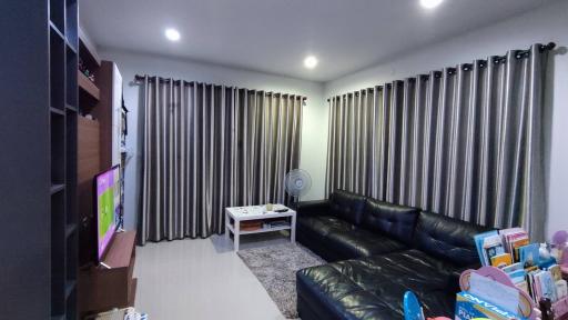 Spacious modern living room with comfortable seating and entertainment setup