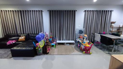 Spacious living room with modern furniture and children