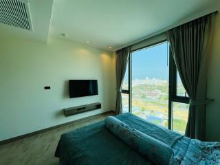 Modern bedroom with city view and large windows