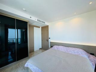 Modern bedroom with large bed and balcony access