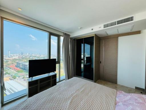 Modern bedroom with large window and city view