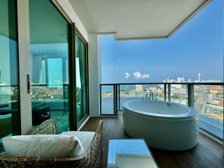 Stylish balcony with a freestanding bathtub overlooking a city view