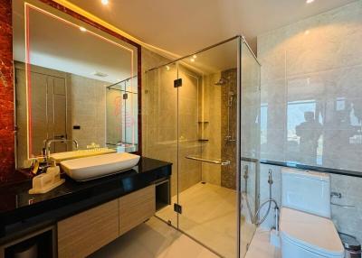 Modern bathroom interior with glass shower and illuminated mirror