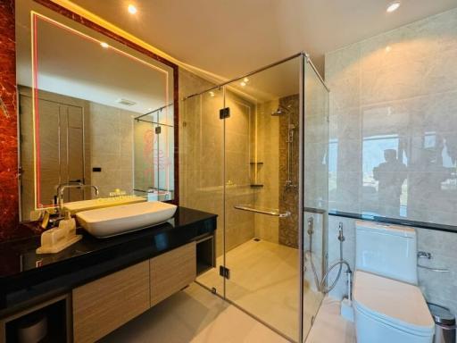 Modern bathroom interior with glass shower and illuminated mirror