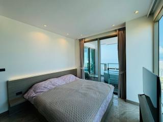 Modern bedroom with a sea view and balcony access