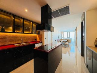 Modern kitchen with red countertop and view into living room