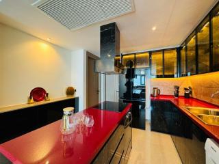 Modern kitchen with red countertops and black cabinets