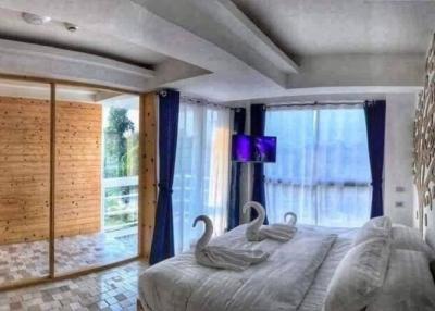 Modern bedroom with a flat-screen TV and balcony access