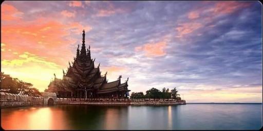Exotic temple structure by the waterfront at sunset