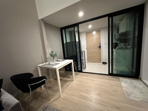 Modern living room with glass partition and dining area