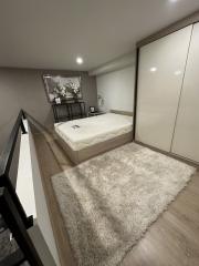 Modern bedroom with large bed and ample storage