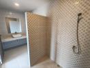 Modern tiled bathroom with walk-in shower and wall-mounted sink