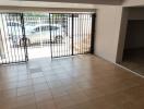 Spacious building interior with secured gate and tiled flooring