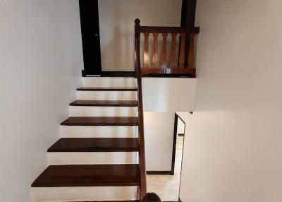 Wooden staircase with white walls in a modern home interior