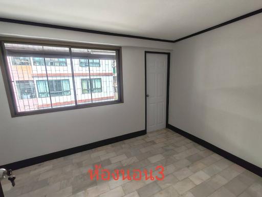 Empty bedroom with tiled flooring and large window