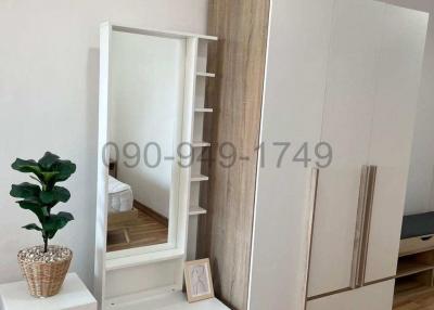 Modern bedroom with stylish wardrobe and full-length mirror