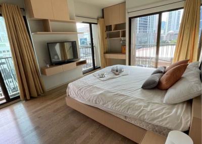 Modern bedroom with large windows and city view