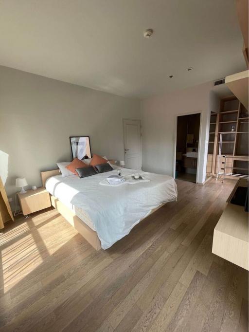 Spacious bedroom with natural lighting and hardwood floors